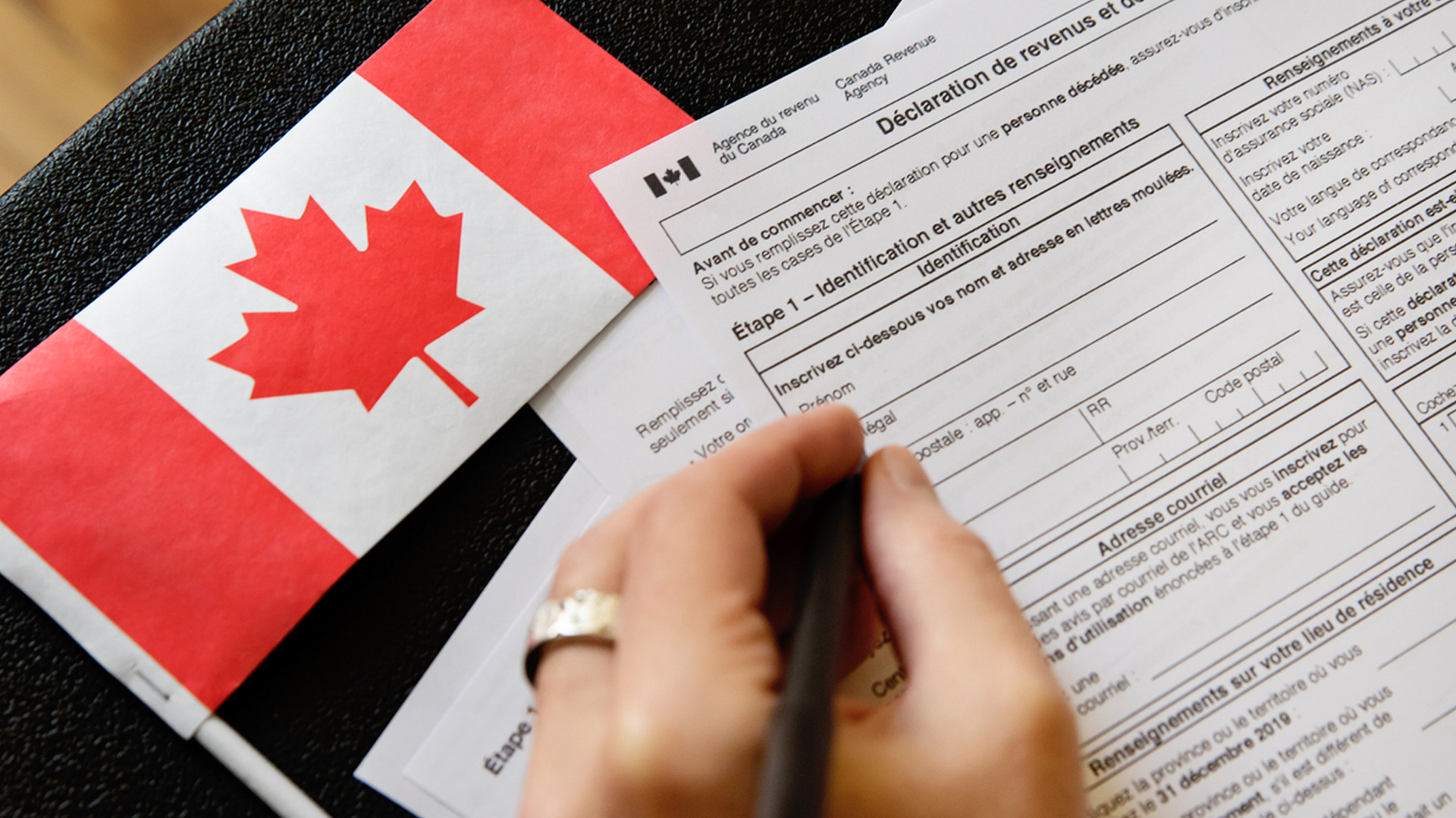 Professional Canadian tax preparation with TAX wooden blocks, Canadian currency, and calculator representing expert CPA services